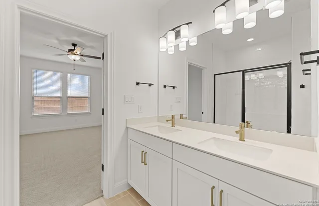 a bathroom with a sink vanity and a mirror