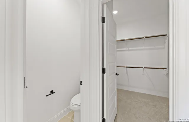 a bathroom with a granite countertop shower and a toilet