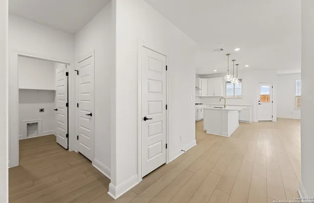 a view of a kitchen with white appliances cabinets and a refrigerator