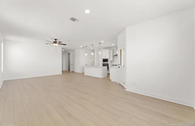 a view of a kitchen with a sink and a refrigerator
