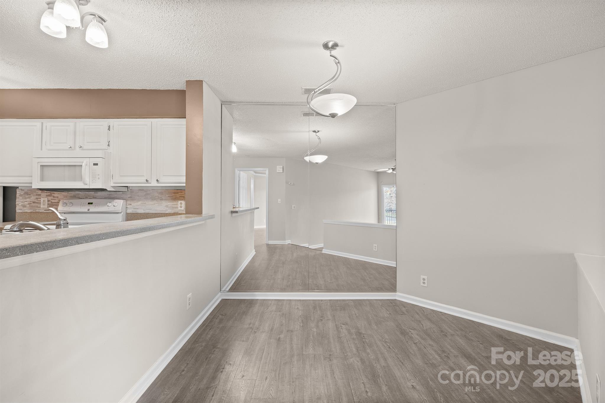 18809 Nautical Drive, Unit 202 Cornelius, NC 28031 - Photo 21 of 32 a view of a kitchen with a sink and wooden floor