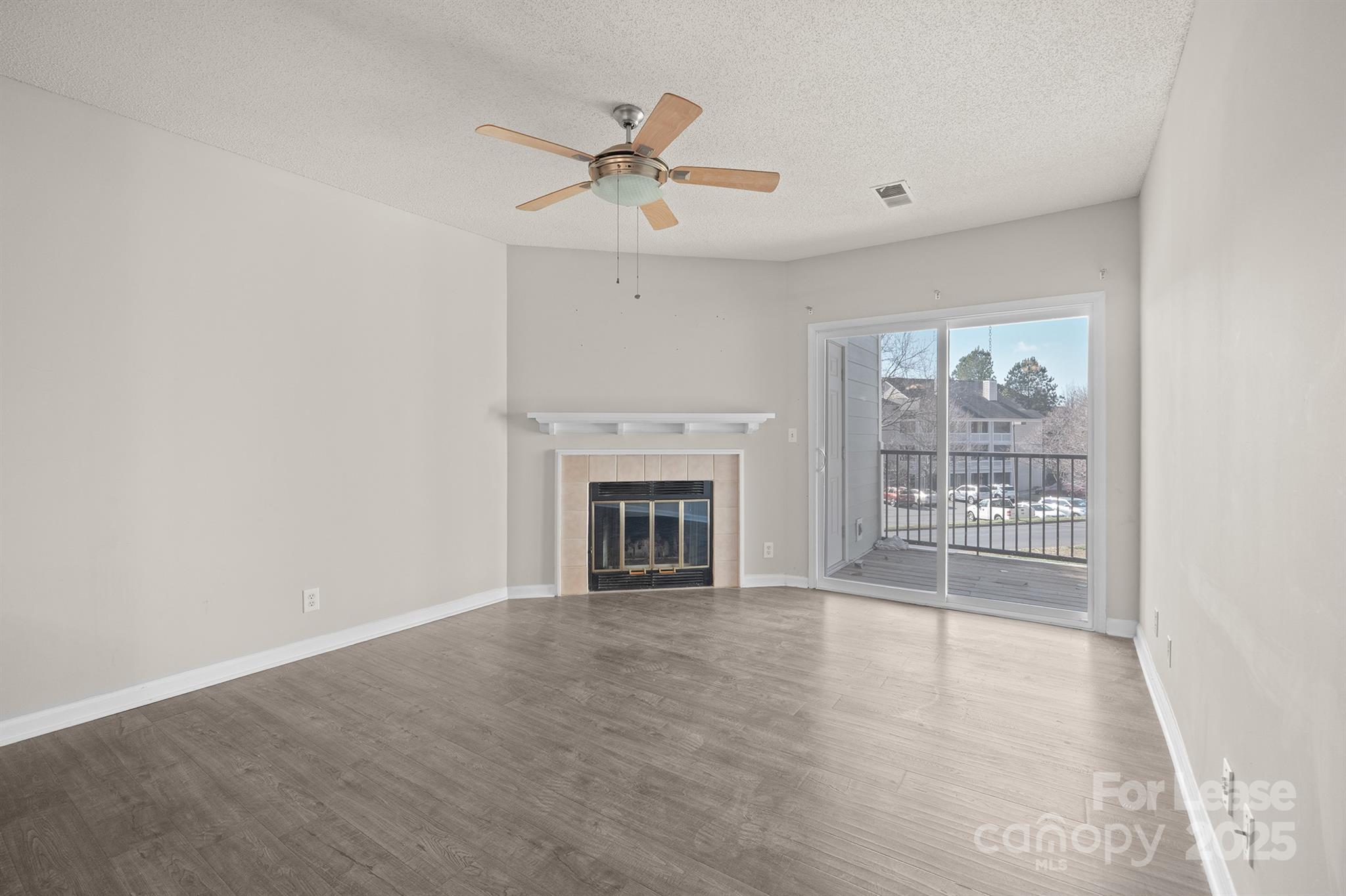 18809 Nautical Drive, Unit 202 Cornelius, NC 28031 - Photo 29 of 32 a view of an empty room with a fireplace and a window