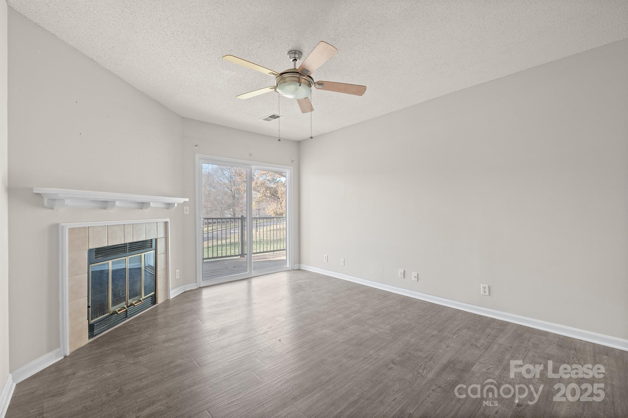 18809 Nautical Drive, Unit 202 Cornelius, NC 28031 - Photo 31 of 32 an empty room with windows fireplace