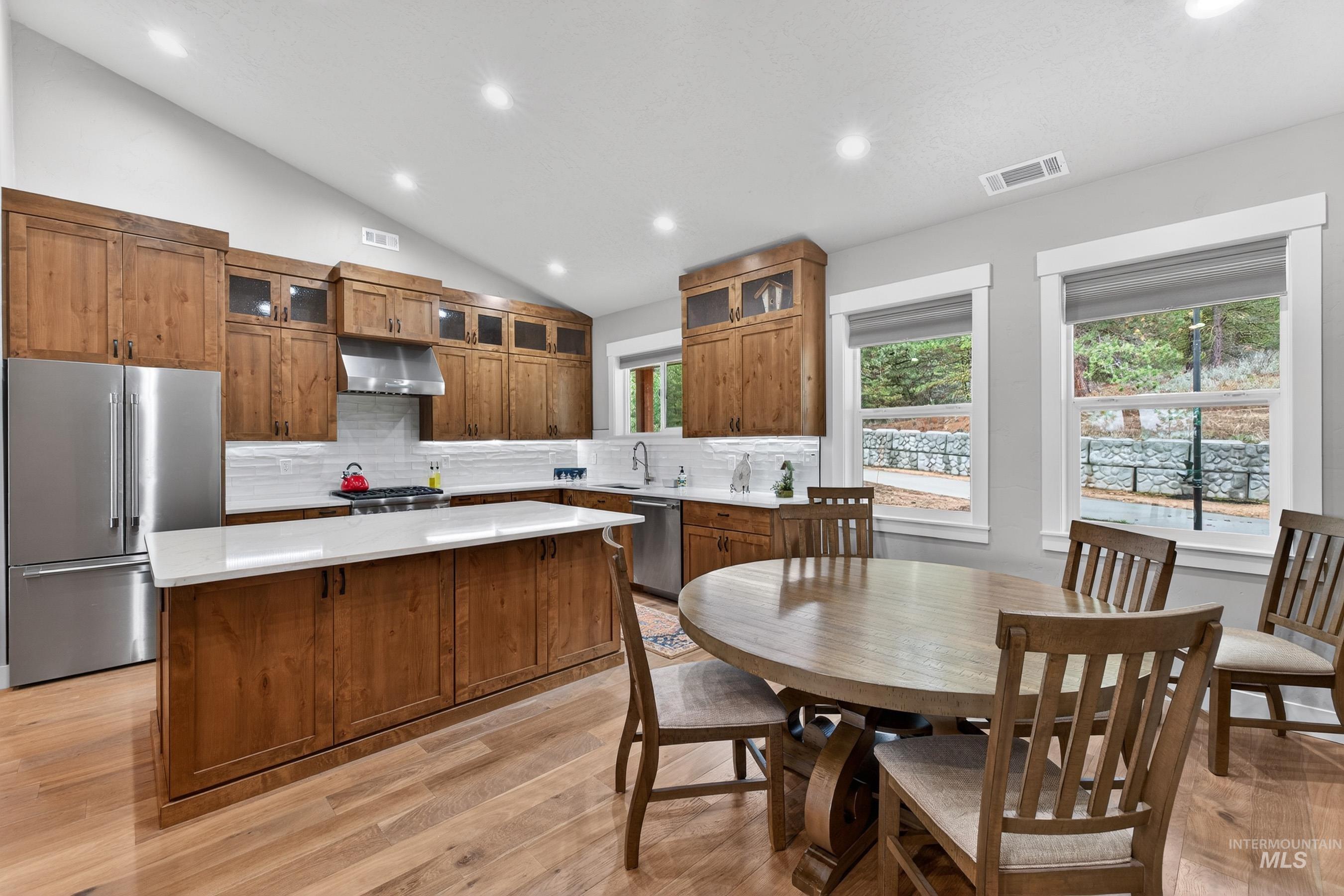 10191 Timberrim Drive Cascade, ID 83611 - Photo 13 of 44 Kitchen featuring stainless steel appliances, a center island, light wood-style flooring, recessed lighting, and glass insert cabinets