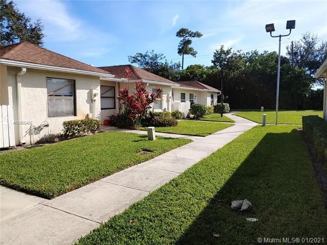 a front view of a house with a yard and porch