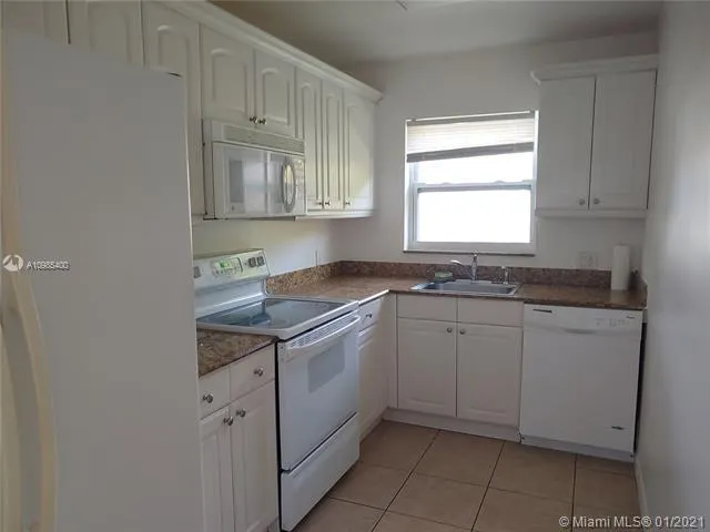 a view of a room with a table chairs and chandelier