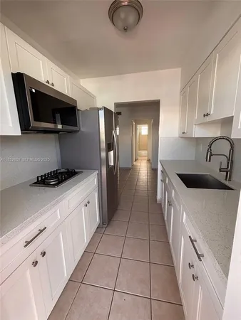 a kitchen with stainless steel appliances granite countertop a sink and a stove