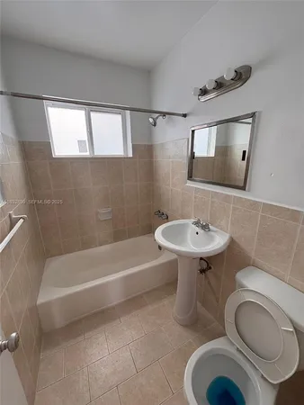 a bathroom with a sink a toilet and bathtub