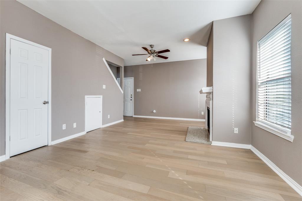 8750 Park Lane, Unit 147 Dallas, TX 75231 - Photo 13 of 20 Unfurnished living room with ceiling fan, a fireplace with flush hearth, light wood-style floors, and recessed lighting