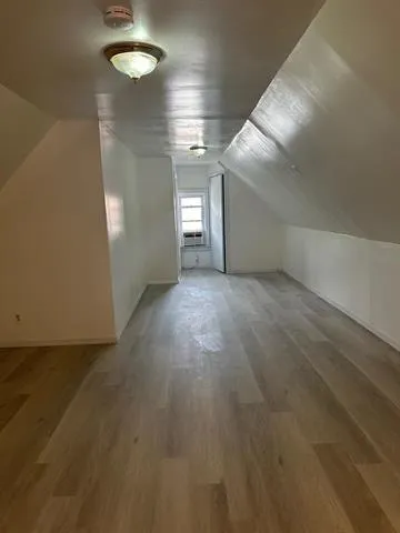 an empty room with windows and entrance