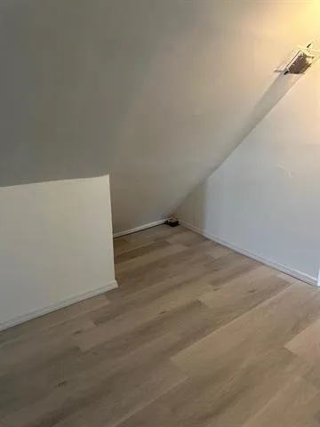 an empty room with wooden floor