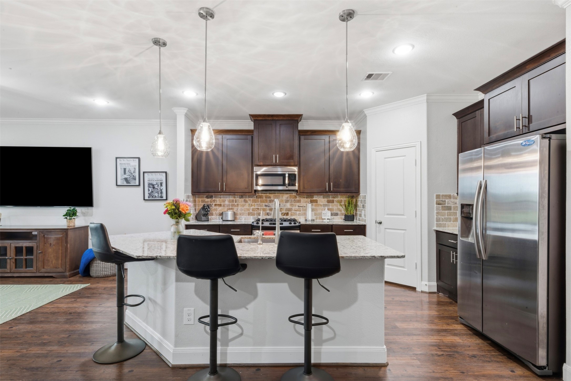 706 Water Street Webster, TX 77598 - Photo 4 of 23 Streamlined and functional, the kitchen opens beautifully to the living space for easy entertaining.