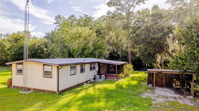 a front view of a house with yard porch and furniture