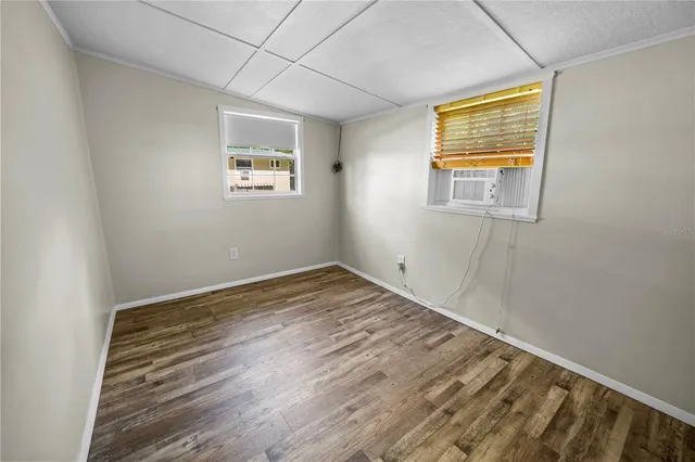 a view of empty room with wooden floor