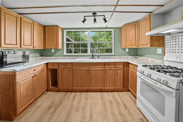 a kitchen with a sink stove and cabinets