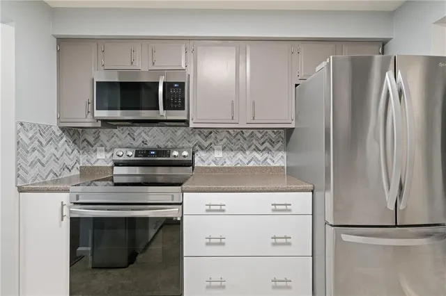a kitchen with appliances cabinets and a counter top space