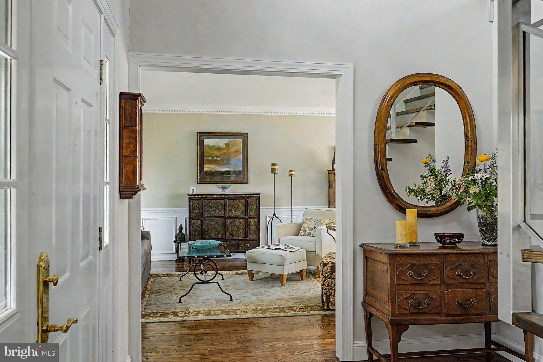 4009 Smoke Road Doylestown, PA 18902 - Photo 15 of 52 a living room with furniture a mirror and a fireplace