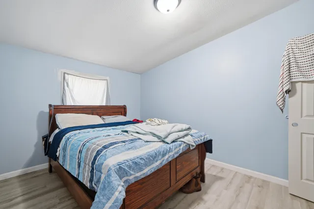 a bed sitting in a bedroom next to a window