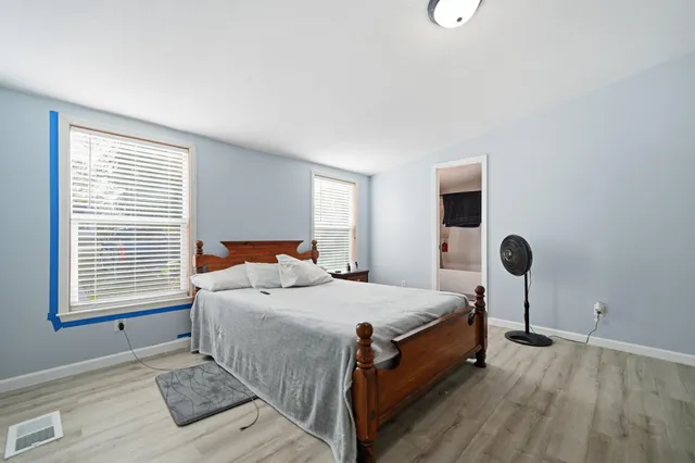 a bedroom with a bed and a table