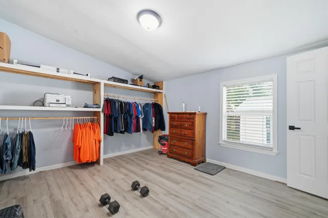 a view of room with furniture and wooden floor
