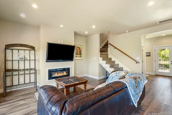 a living room with furniture fireplace and flat screen tv