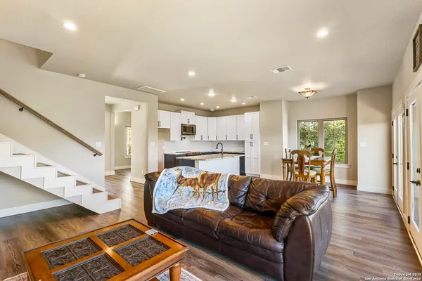 a view of a living room kitchen and a wooden floor