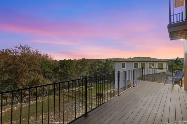 a view of a balcony with wooden floor and city view