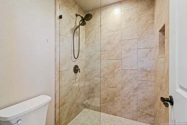 a bathroom with a shower and toilet
