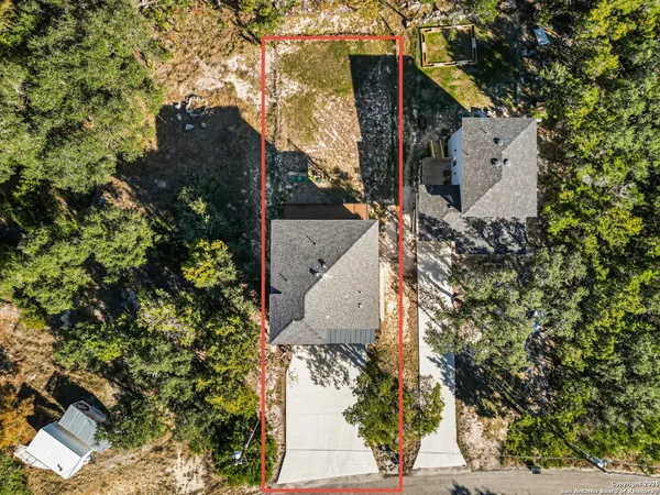 an aerial view of a house with outdoor space