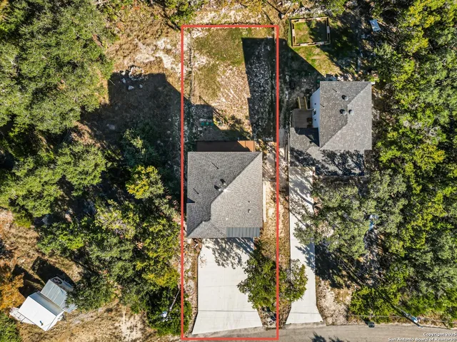 an aerial view of a house with outdoor space