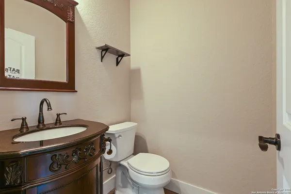 a bathroom with a sink a toilet and mirror