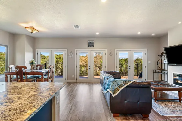 a living room with furniture and a flat screen tv with wooden floor