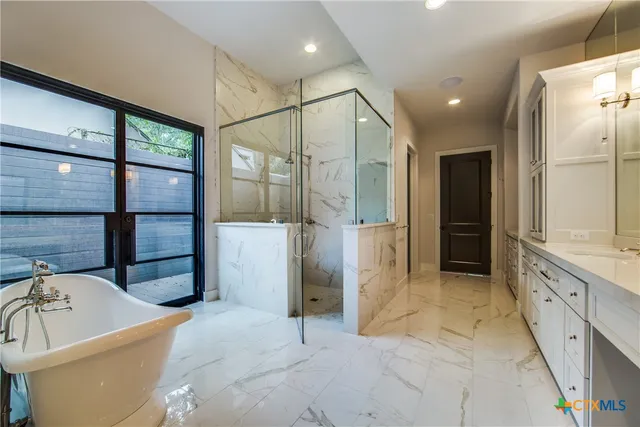 a bathroom with a bathtub and a shower