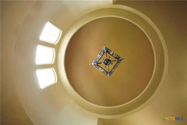 a living room with furniture fireplace and a large window
