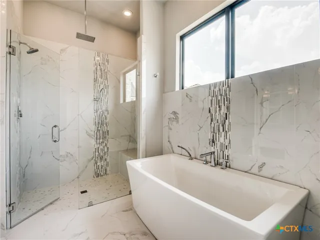 a kitchen with a table chairs and white cabinets
