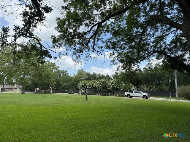 a view of a park with swings and trees