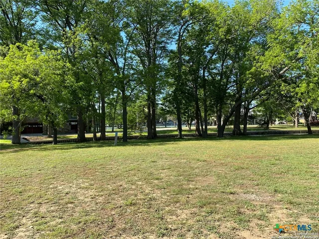 a swimming pool with trees in the background