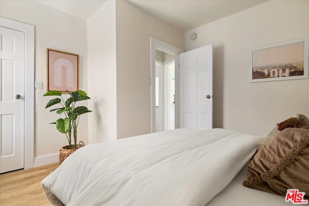 621 Isabel Street Los Angeles, CA 90065 - Photo 17 of 38 a bedroom with a bed and a potted plant