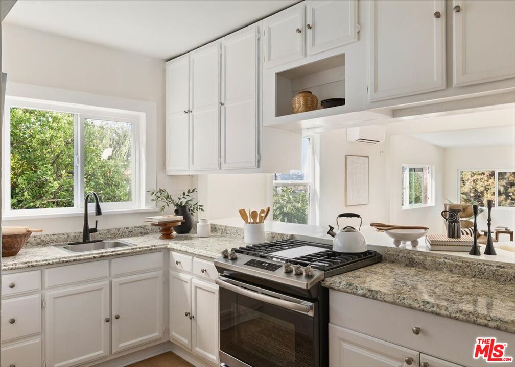 621 Isabel Street Los Angeles, CA 90065 - Photo 10 of 38 a kitchen with granite countertop white cabinets and a stove