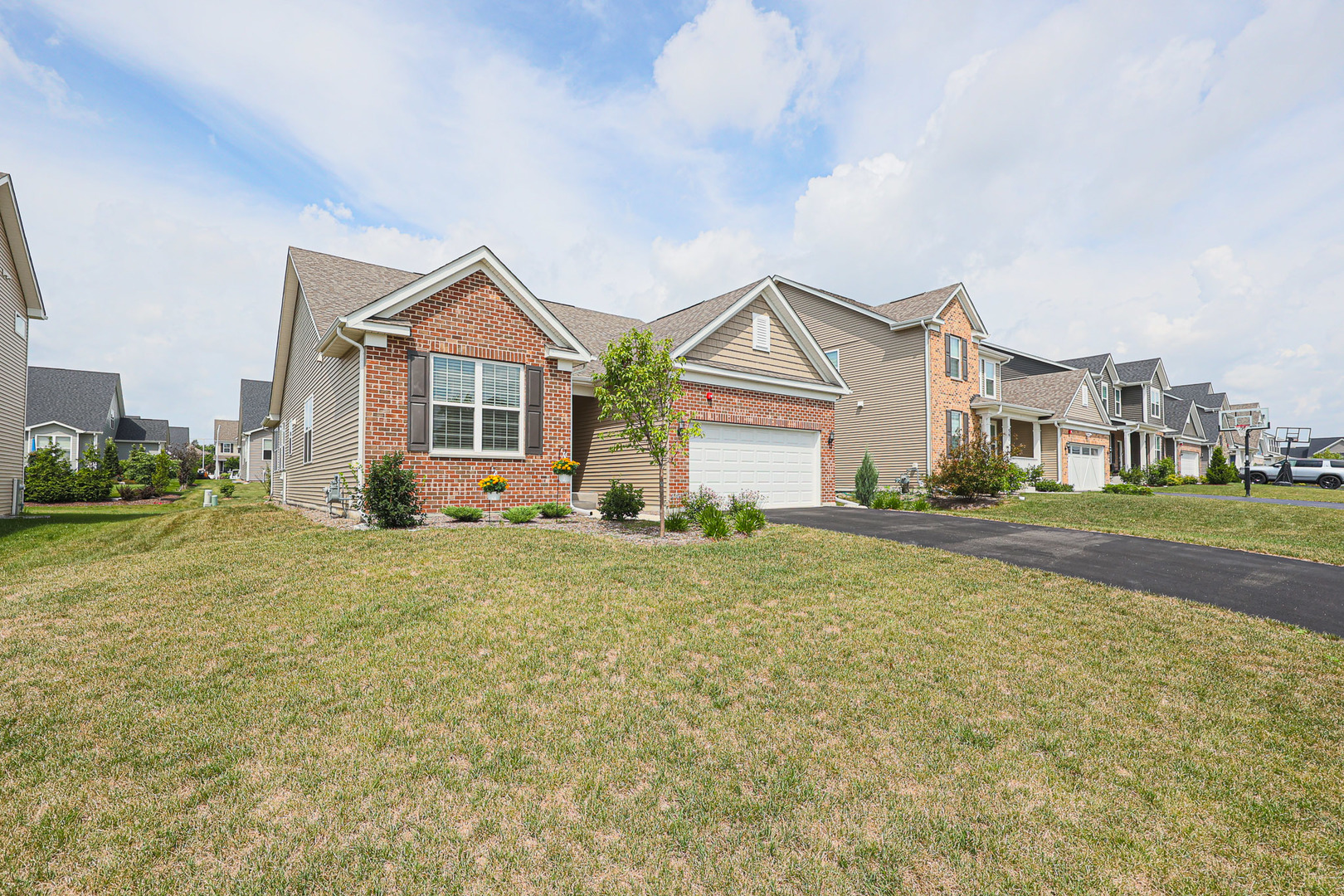 a front view of a house with a garden and yard