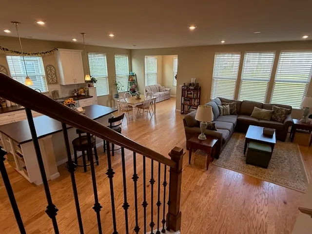 a large kitchen with stainless steel appliances sink a microwave and cabinets