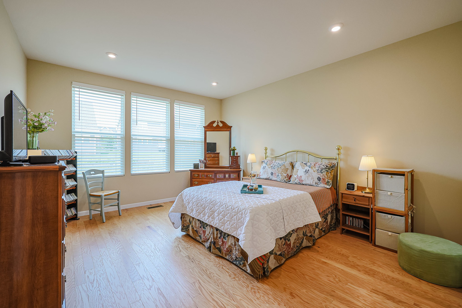 580 North Highlander Way Addison, IL 60101 - Photo 21 of 63 a bedroom with a bed and wooden floor