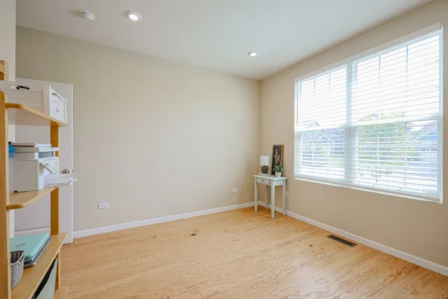 a bedroom with a bed and a flat tv screen on dresser