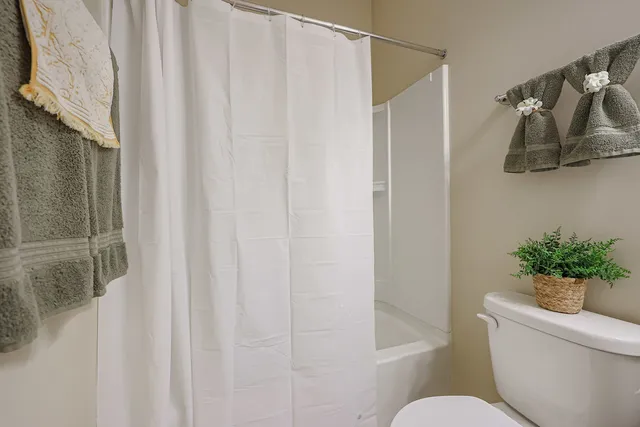 a living room with furniture and a book shelf