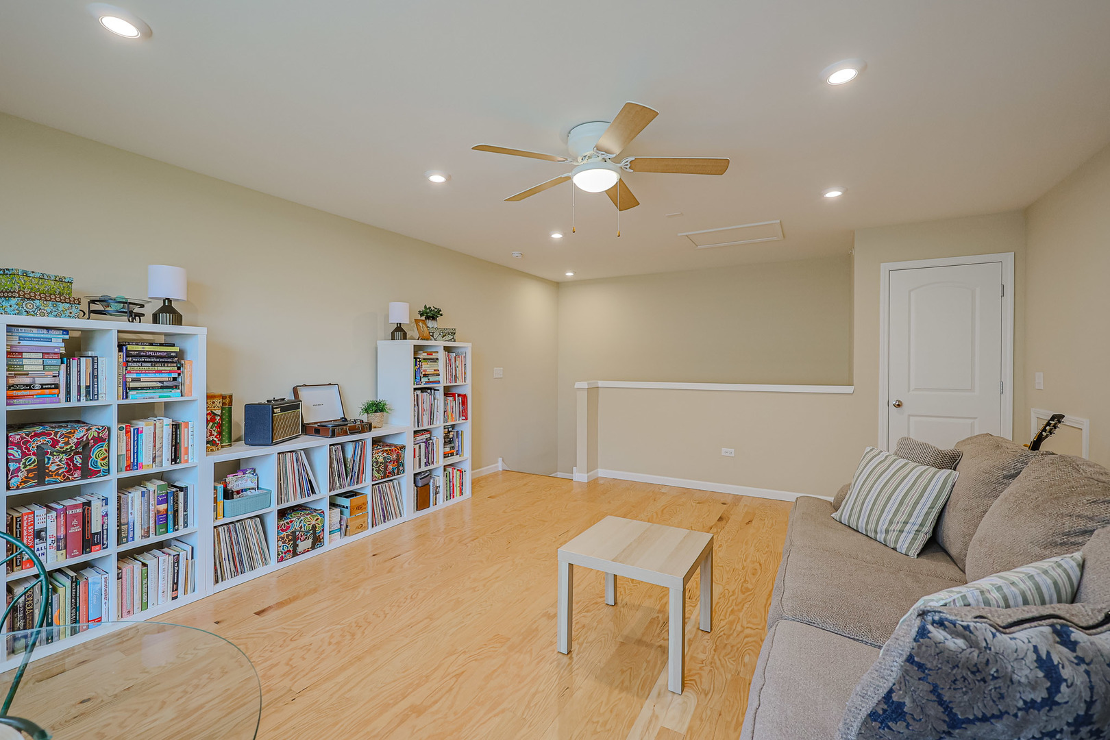 580 North Highlander Way Addison, IL 60101 - Photo 46 of 63 a living room with a couch and a book shelf