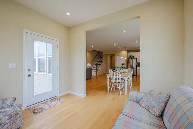 a view of a house with a big yard and large trees