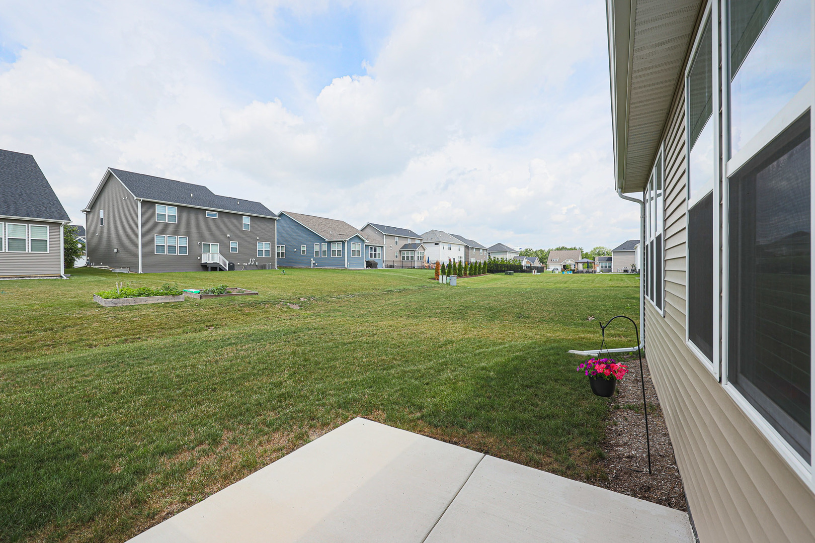 580 North Highlander Way Addison, IL 60101 - Photo 59 of 63 a view of a garden with a building in the background