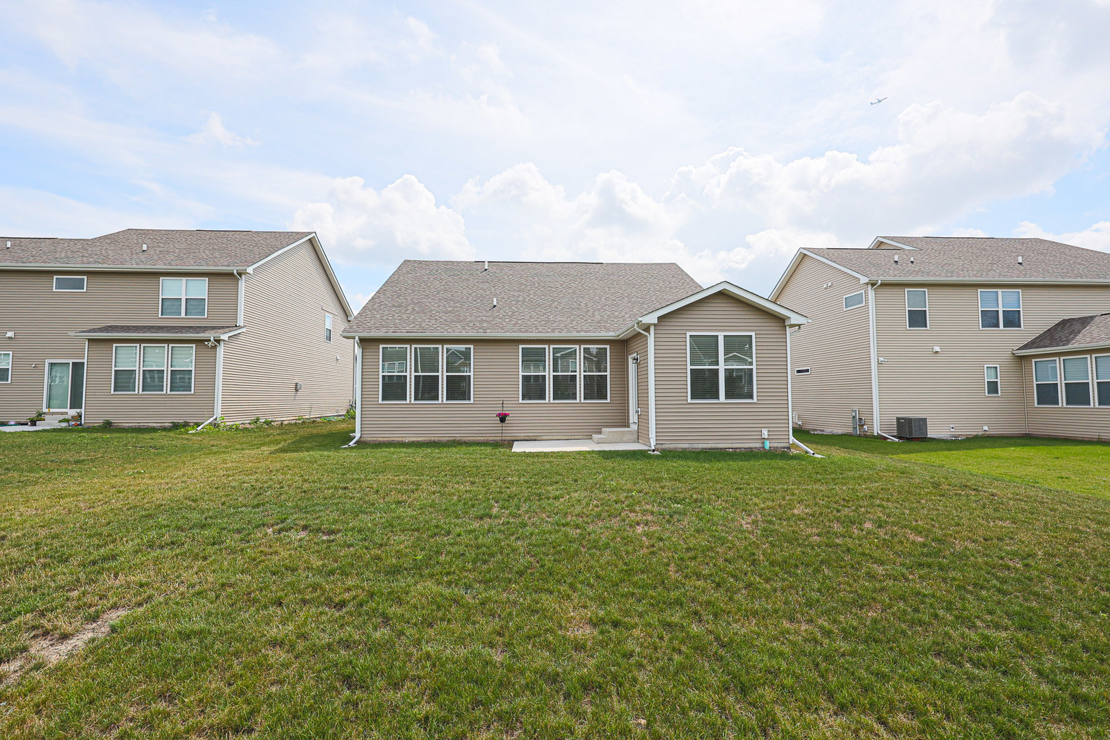 580 North Highlander Way Addison, IL 60101 - Photo 62 of 63 a view of a yard in front of a house with a large tree