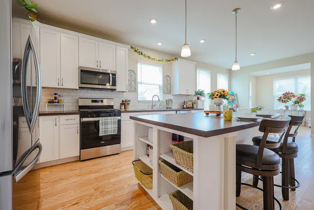 a kitchen with stainless steel appliances a sink stove and cabinets