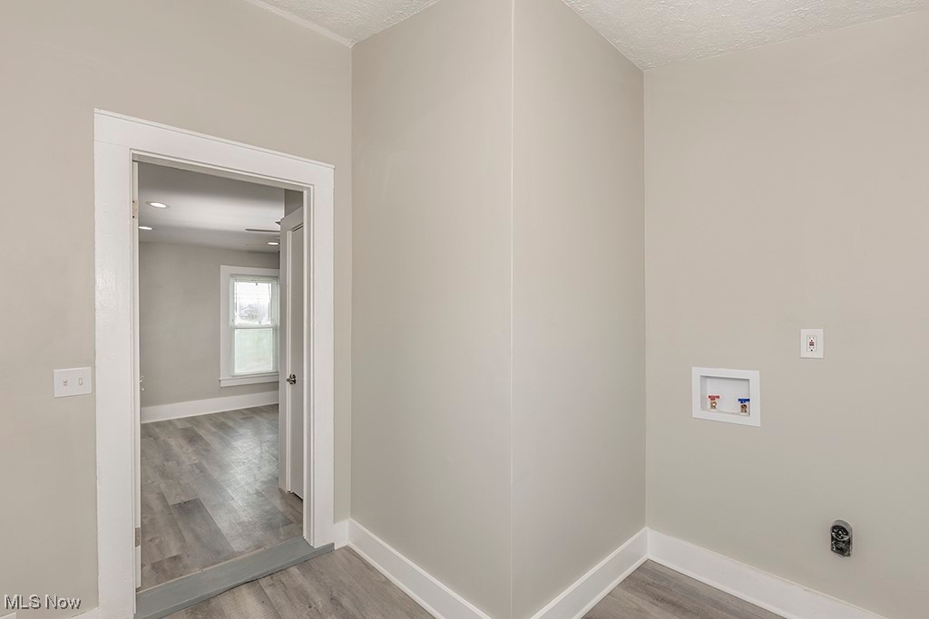 12447 Chillicothe Road Chesterland, OH 44026 - Photo 21 of 42 Washroom featuring hardwood / wood-style floors, hookup for an electric dryer, a textured ceiling, and washer hookup